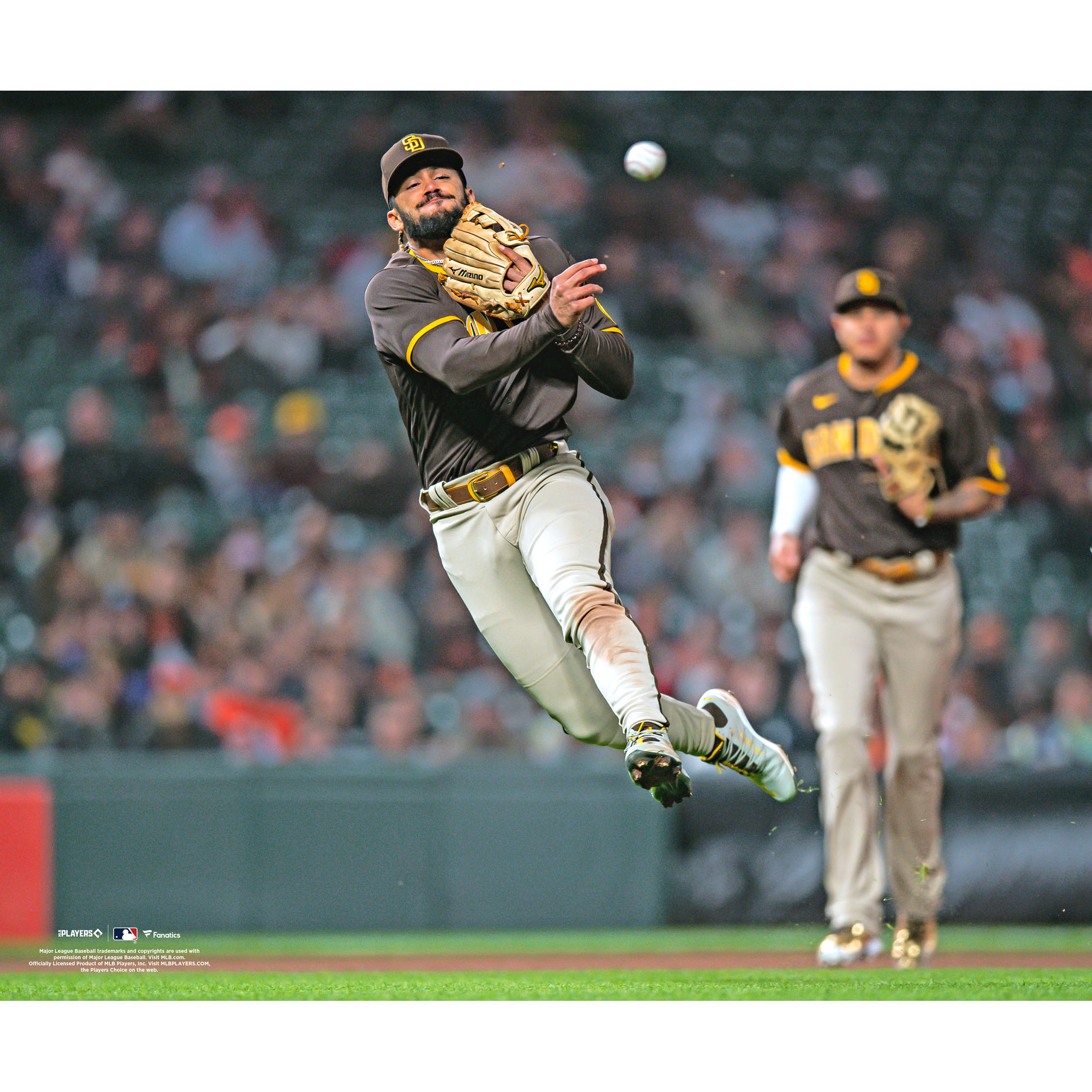 Fernando Tatis Jr. San Diego Padres Unsigned Fielding and Throwing Ball Photograph